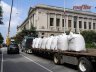 A flatbed trailer of rooflite extensive mc waits for the crane on a closed street